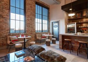 a large room with tables and chairs and windows at Kinn Guesthouse Bay View in Milwaukee