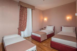 Postel nebo postele na pokoji v ubytování SIRIOHotel