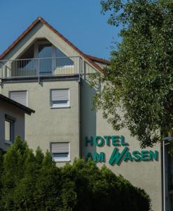 a building with a hotel amwasan sign on it at Hotel am Wasen in Freiberg am Neckar