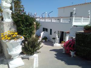 a white building with flowers in front of it at Villa Natalina in Ischia