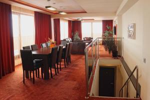 a dining room with a table and chairs at Hotel Premier in Sibiu