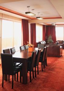 a conference room with a wooden table and chairs at Hotel Premier in Sibiu
