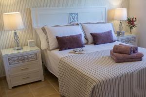 a bedroom with a large bed and two lamps at Beautiful Villa Grace, Caleta de Fuste in Caleta De Fuste +27 photos