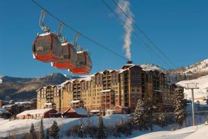 a ski resort with a ski lift in the snow at Grand Summit Lodge by Park City - Canyons Village in Park City