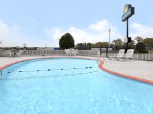 a large swimming pool with chairs at Days Inn by Wyndham Jacksonville in Jacksonville