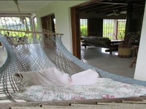 a hammock in the middle of a living room at Light of Dawn in Quepos