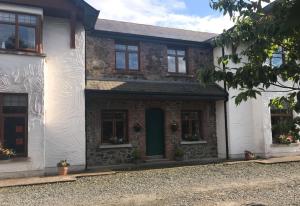 a brick house with a green door and windows at Riverdale in Carlingford