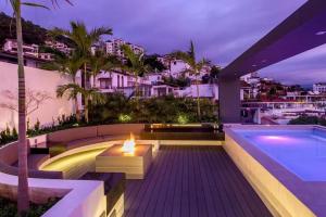 a backyard with a fire pit and a swimming pool at Departamento Zona Romantica in Puerto Vallarta