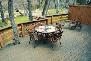 a patio with a table and chairs on a deck at Junipine Resort in Sedona