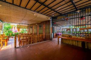 a restaurant with wooden shelves and tables in a room at Dong Xuan Hong Hotel in Phu Quoc