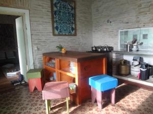 a kitchen with colorful stools and a wooden island at Casa Rodo 53 in Rocha +47 photos