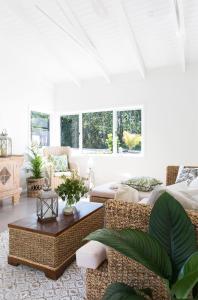 a living room with a couch and a table at Satara Byron Bay - Adults Only in Byron Bay