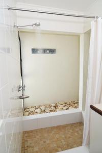 a shower in a bathroom with a shower curtain at Pacific Lagoon Apartments in Port Vila