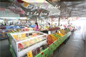 a market with a bunch of fruits and vegetables on display at Shewe Wana Boutique Hotel in Chiang Mai