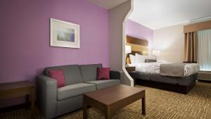 a hotel room with a couch and a bed at Best Western Plus Buda Austin Inn & Suites in Buda