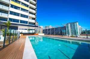 a large swimming pool in a large building at Alcyone Hotel Residences in Brisbane