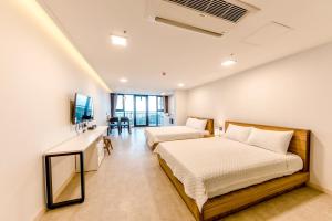 Postel nebo postele na pokoji v ubytování Jeju I've Hotel & Resort