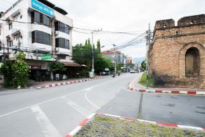 an empty city street with a brick building at Mountain View GuesthouseChiangmai in Chiang Mai