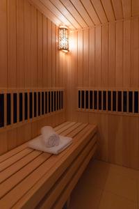 a sauna with a towel sitting on a bench at Fedorov ApartHotel Barnaul in Barnaul