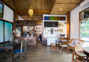 a restaurant with tables and chairs and a counter at Mountain View GuesthouseChiangmai in Chiang Mai