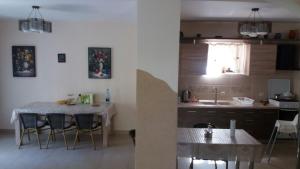 a kitchen and dining room with a table and a sink at Casa Fulg de Nea in Moieciu de Sus +16 photos