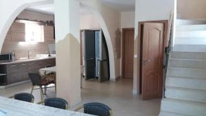 a kitchen with a staircase leading to a kitchen with a door at Casa Fulg de Nea in Moieciu de Sus