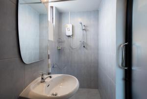 a bathroom with a sink and a shower at Mountain View GuesthouseChiangmai in Chiang Mai
