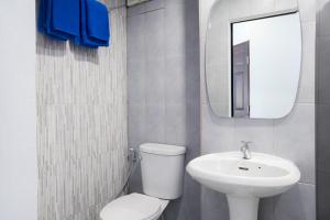 a bathroom with a toilet and a sink and a mirror at Mountain View GuesthouseChiangmai in Chiang Mai