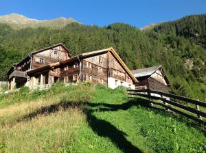 a large wooden house on a hill in the mountains at Ögghof 221 in Kaunertal