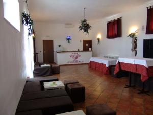 a living room with two tables and a counter in a room at Masseria La Luna Nel Pozzo in Castellana Grotte