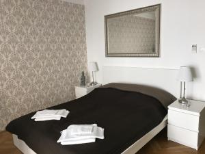 a bed room with a white bedspread and pillows at Budapest Downtown Apartments in Budapest