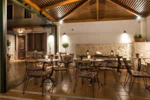 a restaurant with tables and chairs and a stone wall at Veneziano Boutique Hotel in Heraklio