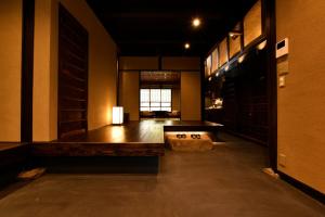 a large room with a table and a large window at Kuraya Jurakudai in Kyoto