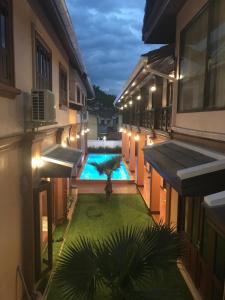 an empty courtyard with a swimming pool in a building at Jasmine Luangprabang Hotel in Luang Prabang