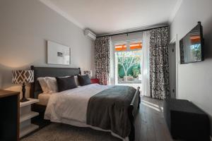 a bedroom with a large bed and a window at Waterstone Lodge in Somerset West