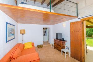 a living room with an orange couch and a television at Son Sabater (Es Moli Nou) in Sa Pobla