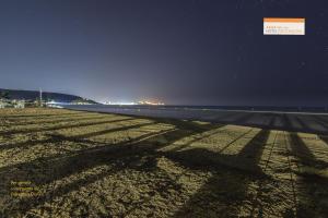 a shadow of a plane on the beach at night at Hotel Portonuovo in Vieste