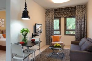 a living room with a couch and a table at Rafael Residence Boutique in Jerusalem