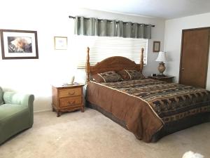 a bedroom with a large bed and a couch at Family Fun House in Big Bear Lake