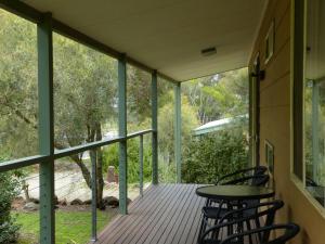 a porch with two chairs and a table on it at Watervale Retreat in Watervale +30 photos