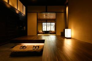 a room with two pairs of shoes on the floor at Kuraya Jurakudai in Kyoto