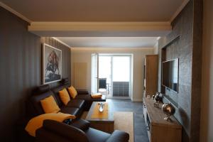 a living room with a couch and a tv at Ferienhof Elbaue in Schönebeck