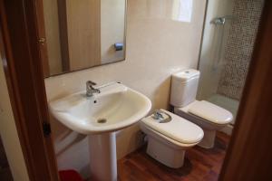 a bathroom with a sink and a toilet at ACP Cambrils Puerto Apartamentos in Cambrils +35 photos