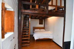 a bedroom with a bunk bed and a ladder at Chinbe D.S House 2 in Beigan