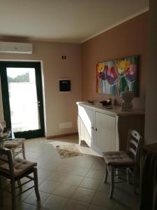 a living room with a desk and chairs and a window at La controra in Fasano