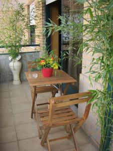 a wooden table and a bench on a patio at Apartamento Alvares Cabral in Vila Nova de Gaia