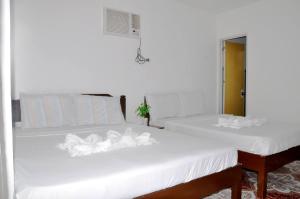Postel nebo postele na pokoji v ubytování Nanette's Tourist Inn