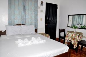 Postel nebo postele na pokoji v ubytování Nanette's Tourist Inn