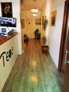 a hallway in a office building with a hard wood floor at Teos Hotel in Antalya