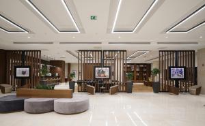 a lobby of a hotel with tables and chairs at Point Hotel Ankara in Ankara